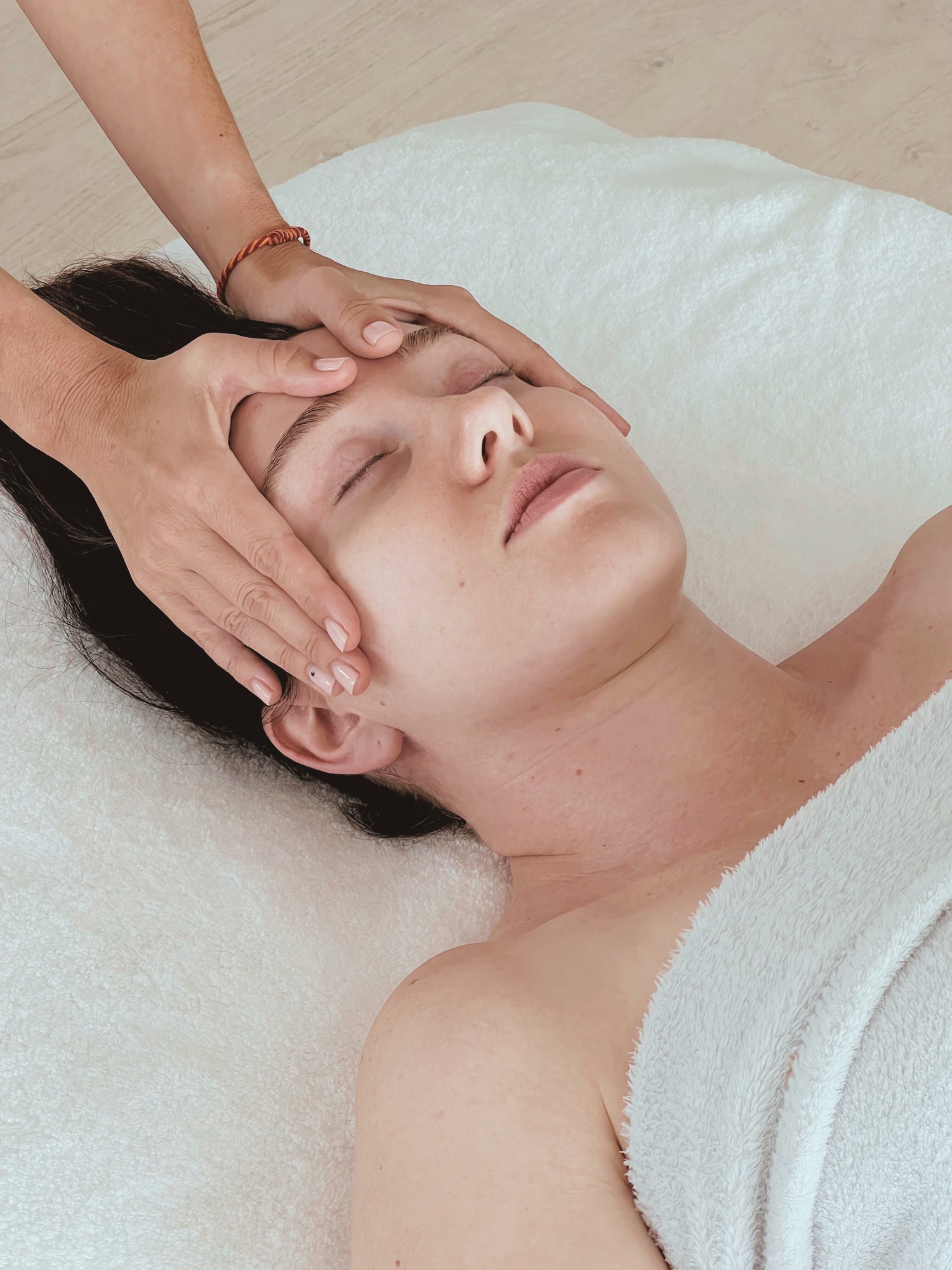 Greethel performing her signature face lifting massage on a client, demonstrating expert techniques in a luxurious spa environment.