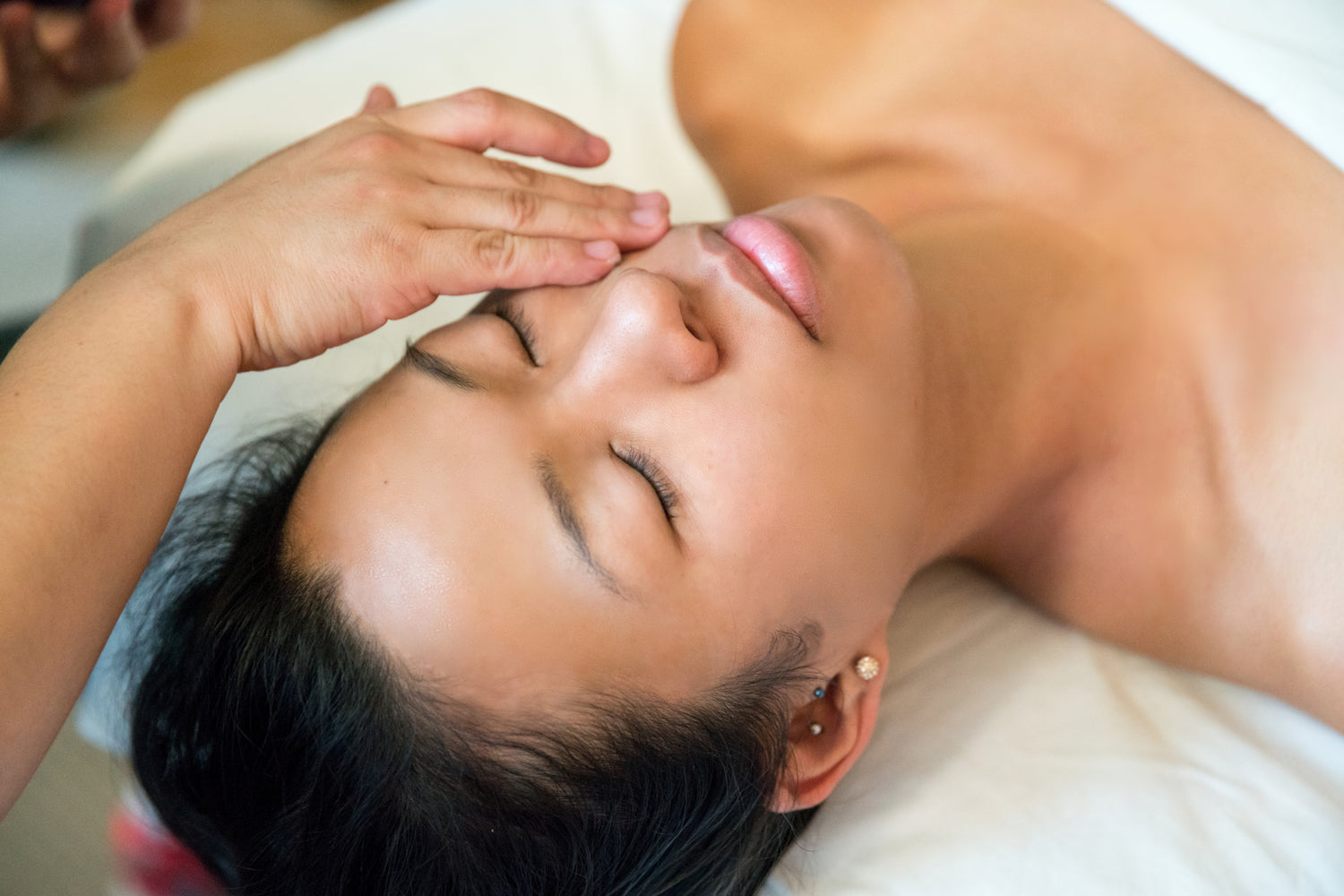 Close-up of a woman’s face showing lifted, youthful contours after receiving Greethel’s signature face lifting massage, highlighting visible anti-aging effects.