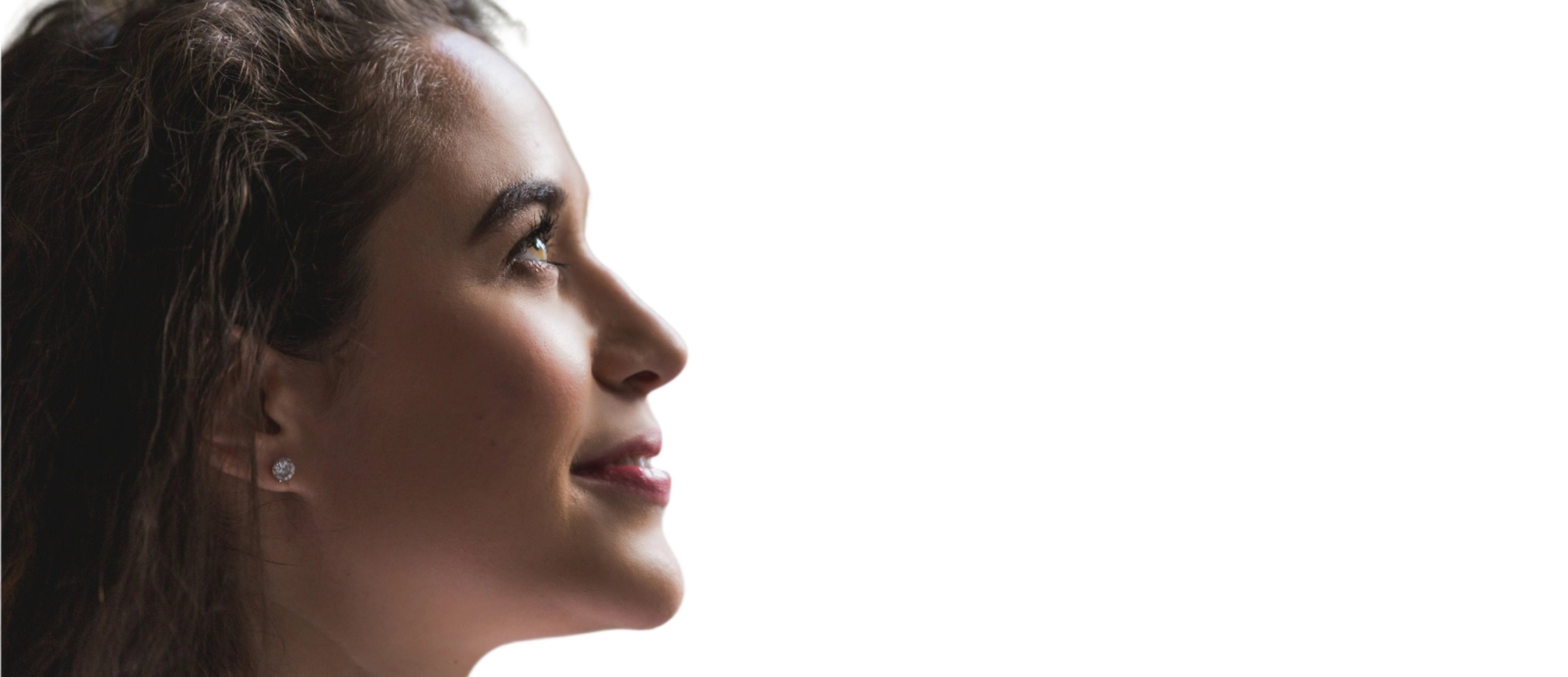 A woman receiving Greethel’s Signature Face Lifting Massage, focusing on facial sculpting and relaxation in a serene, luxury setting.