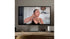 Woman on a video call displayed on a computer screen in a home setting.